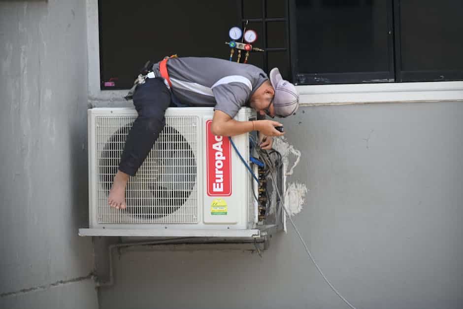 HVAC technician repairing AC unit